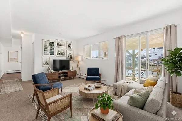 a living room with furniture a flat screen tv and a large window