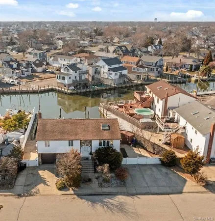 an aerial view of a house with a lake view