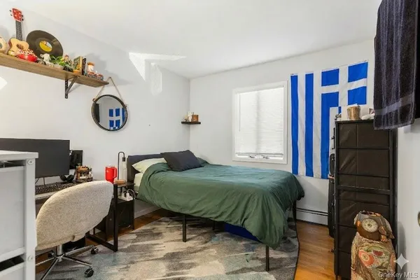 a bedroom with a bed and dresser