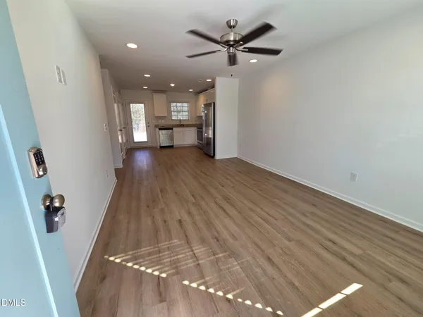 wooden floor in an empty room with a window
