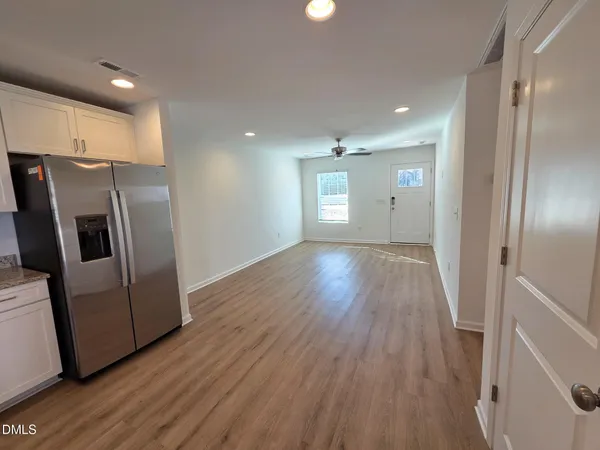 a view of a kitchen with wooden floor and electronic appliances