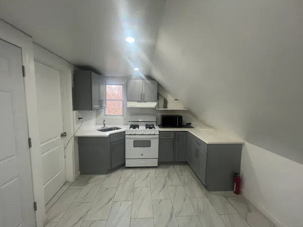 a kitchen with a sink cabinets and stainless steel appliances