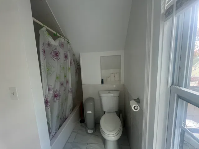 a bathroom with a toilet and a shower