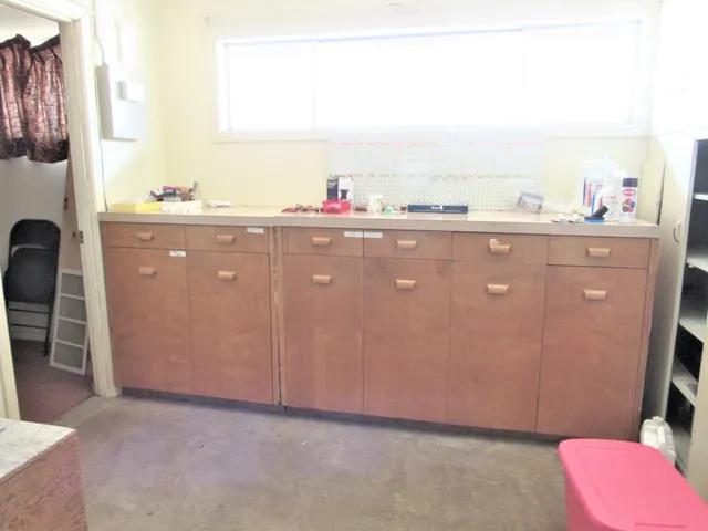 a view of a kitchen with a sink and a cabinet