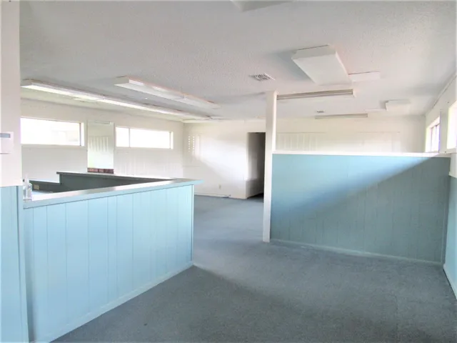 a view of a kitchen with a sink and dishwasher cabinets