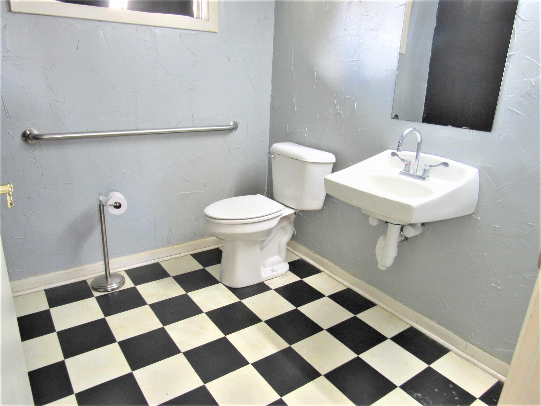 1116 North Fulton Street Wharton, TX 77488 - Photo 27 of 45 a bathroom with a black and white checkered floor