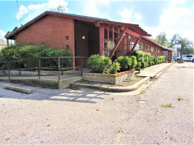 a view of a street with houses on both side of it