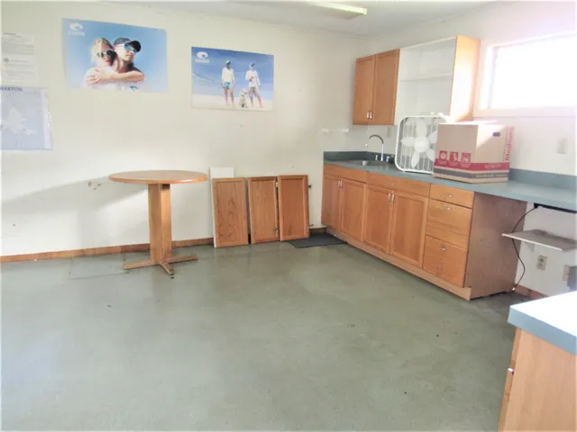 a kitchen with sink a window and cabinets