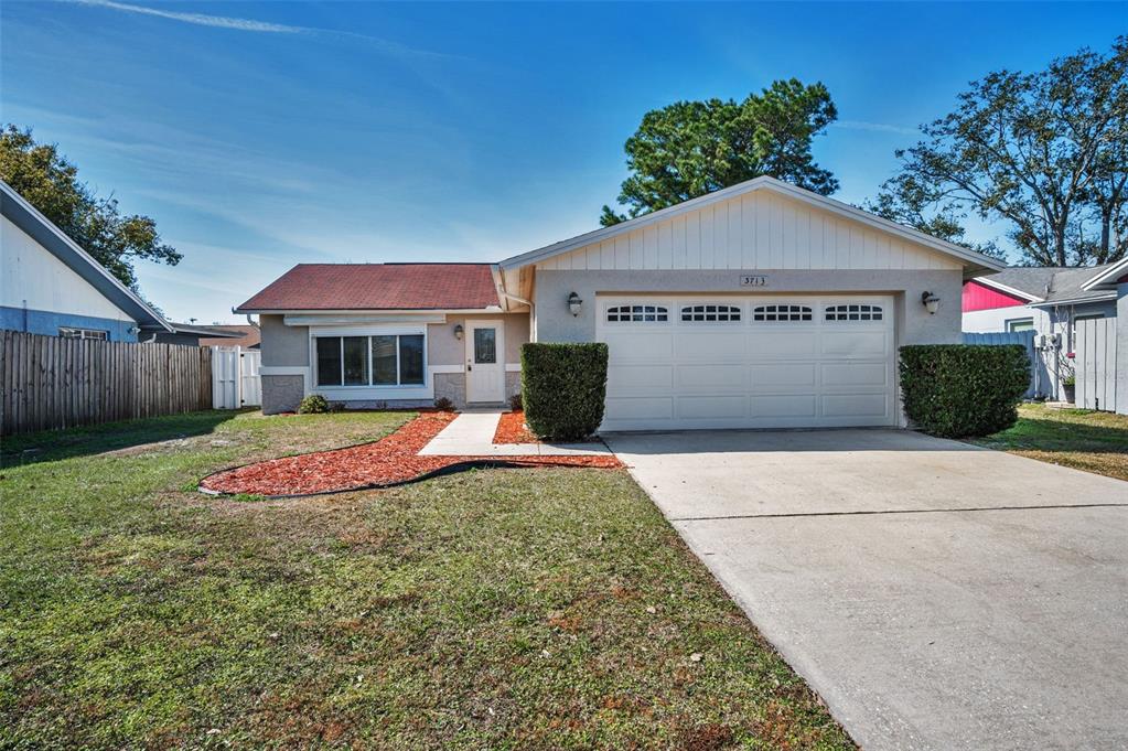 3713 Modesto Street New Port Richey, FL 34655 - Photo 1 of 1 a view of house and outdoor space with yard