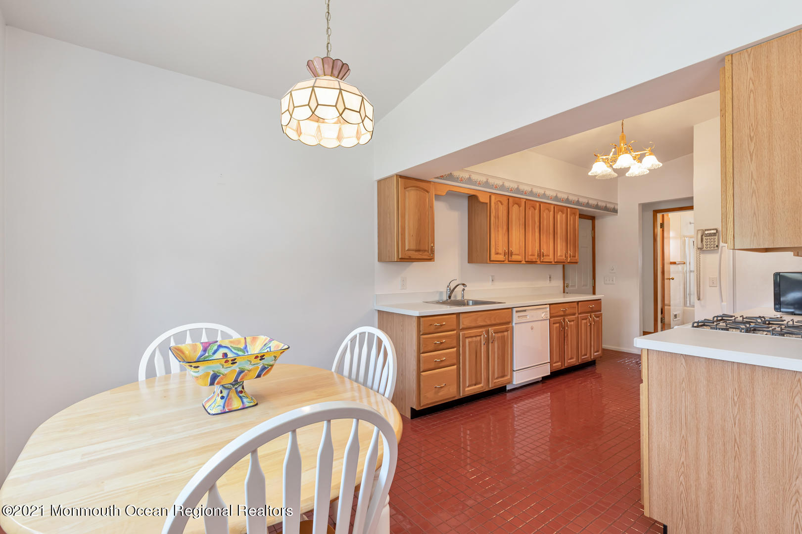 210 Middle Road Hazlet, NJ 07730 - Photo 10 of 30 a kitchen with granite countertop a sink a stove a dining table and chairs