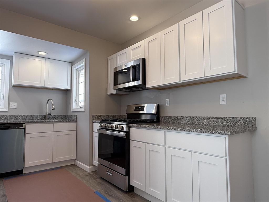 703 Mill Street Marion, MA 02738 - Photo 8 of 20 a kitchen with stainless steel appliances granite countertop a sink and a stove
