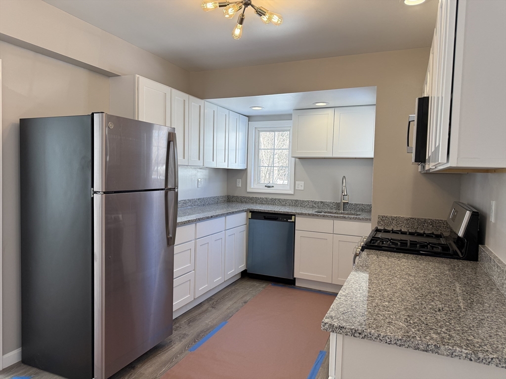 703 Mill Street Marion, MA 02738 - Photo 9 of 20 a kitchen with a refrigerator sink and cabinets
