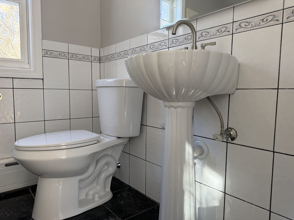 703 Mill Street Marion, MA 02738 - Photo 10 of 20 a bathroom with a sink toilet and shower
