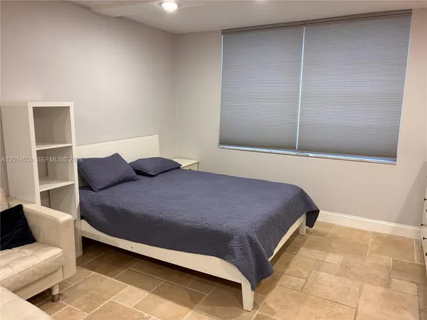 a bedroom with a bed and a chair