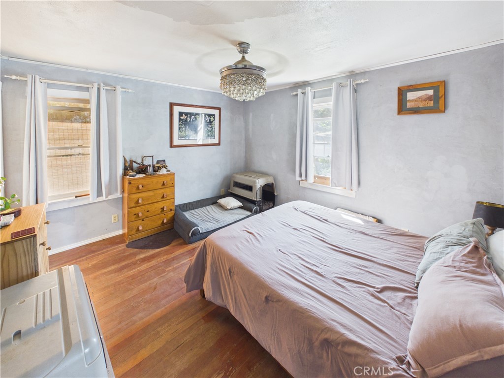 4208 Ramsden Road Mariposa, CA 95338 - Photo 14 of 42 a bedroom with a bed and wooden floor