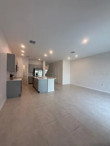 a view of a kitchen with a sink and a refrigerator