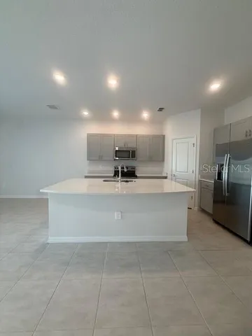 a view of kitchen with stainless steel appliances cabinets