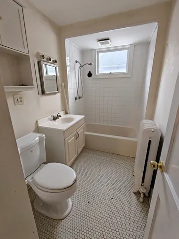 a bathroom with a toilet a sink and a mirror