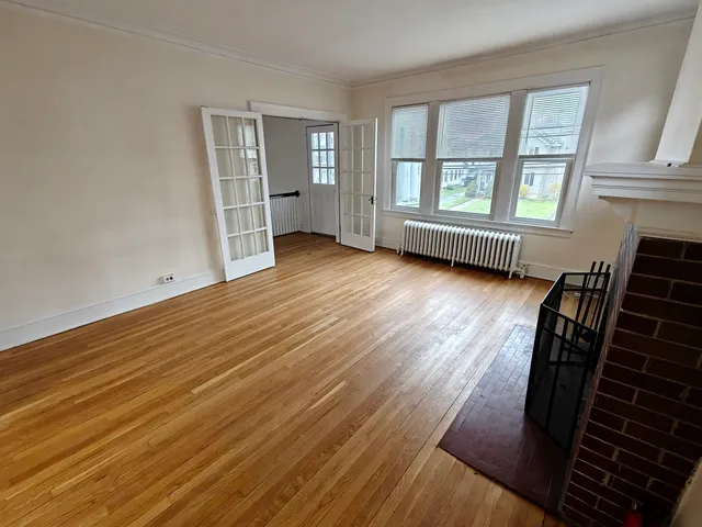 wooden floor in an empty room with a window