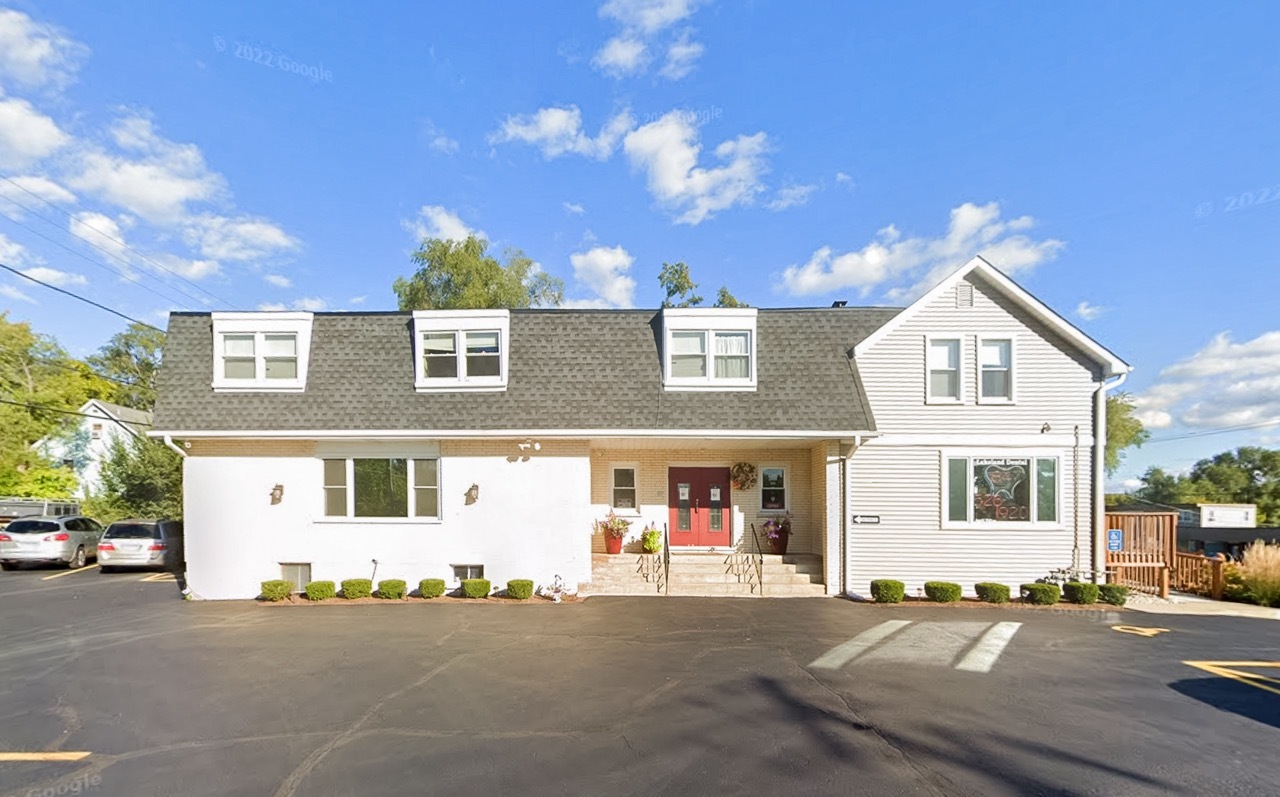 106 East State Road, Unit 2B Island Lake, IL 60042 - Photo 1 of 18 a front view of a house with a yard