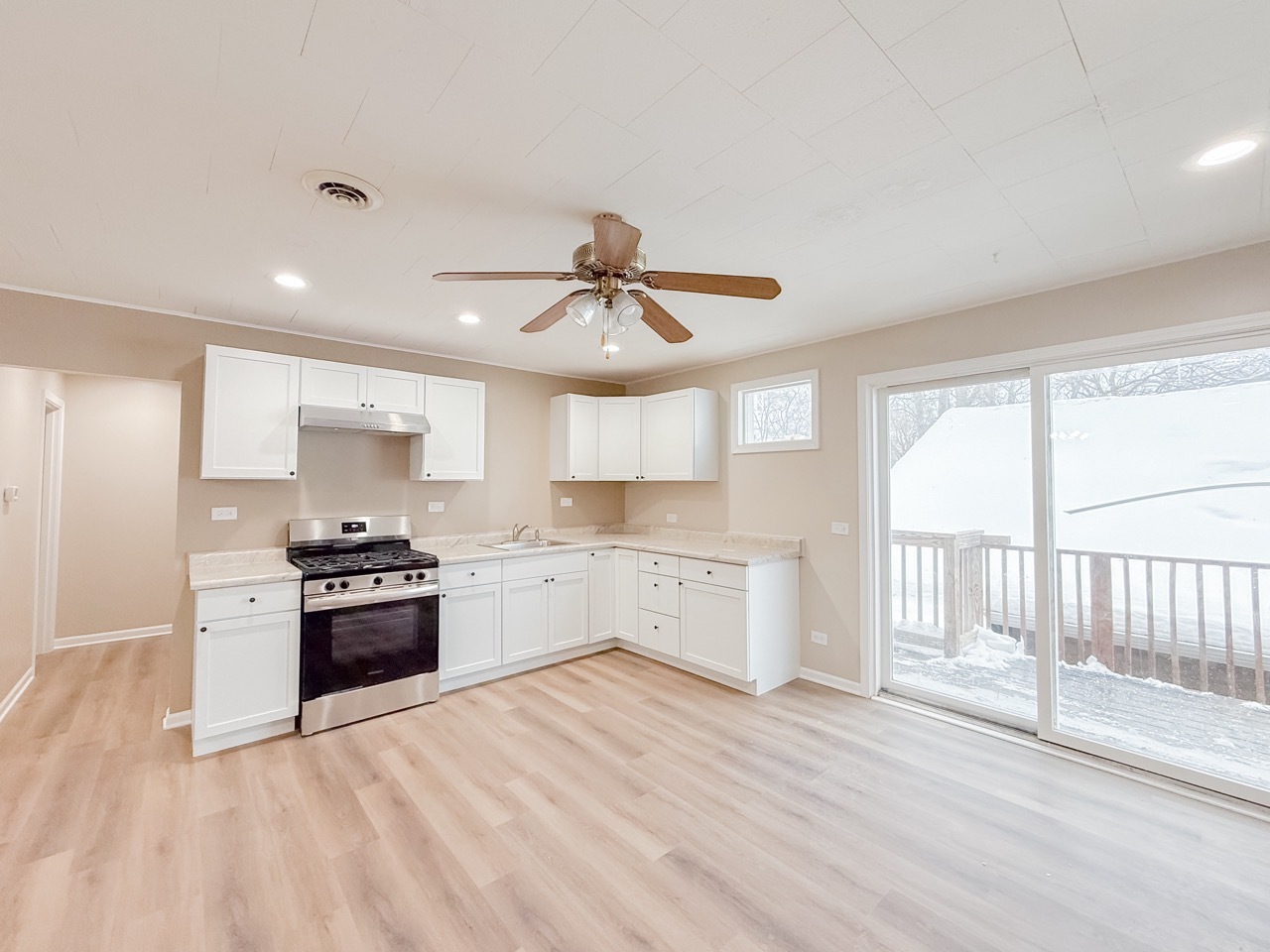 106 East State Road, Unit 2B Island Lake, IL 60042 - Photo 5 of 18 a open kitchen with granite countertop a stove top oven sink and cabinets
