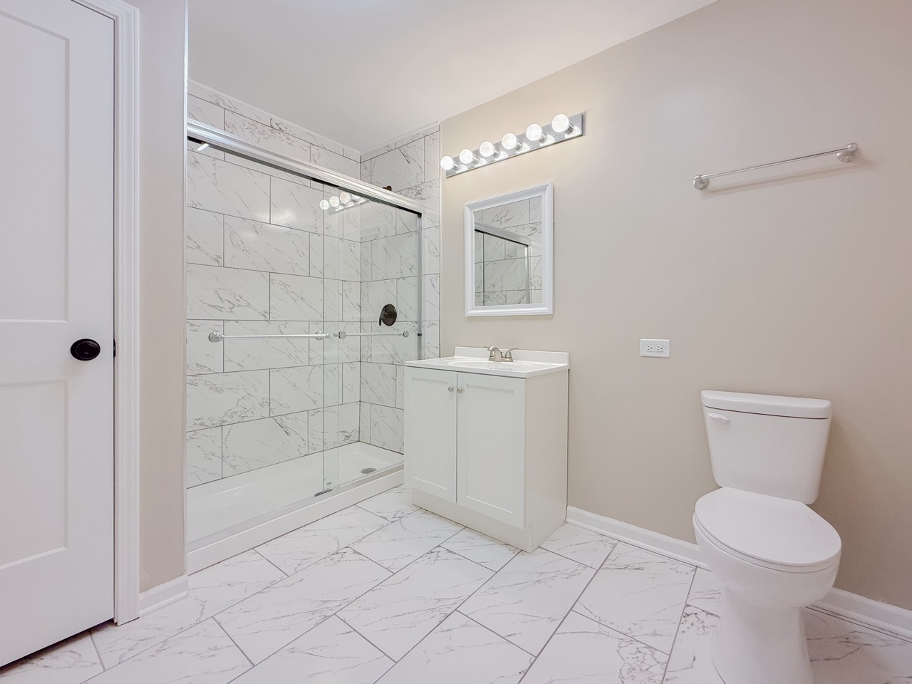 106 East State Road, Unit 2B Island Lake, IL 60042 - Photo 8 of 18 a bathroom with a toilet sink and shower