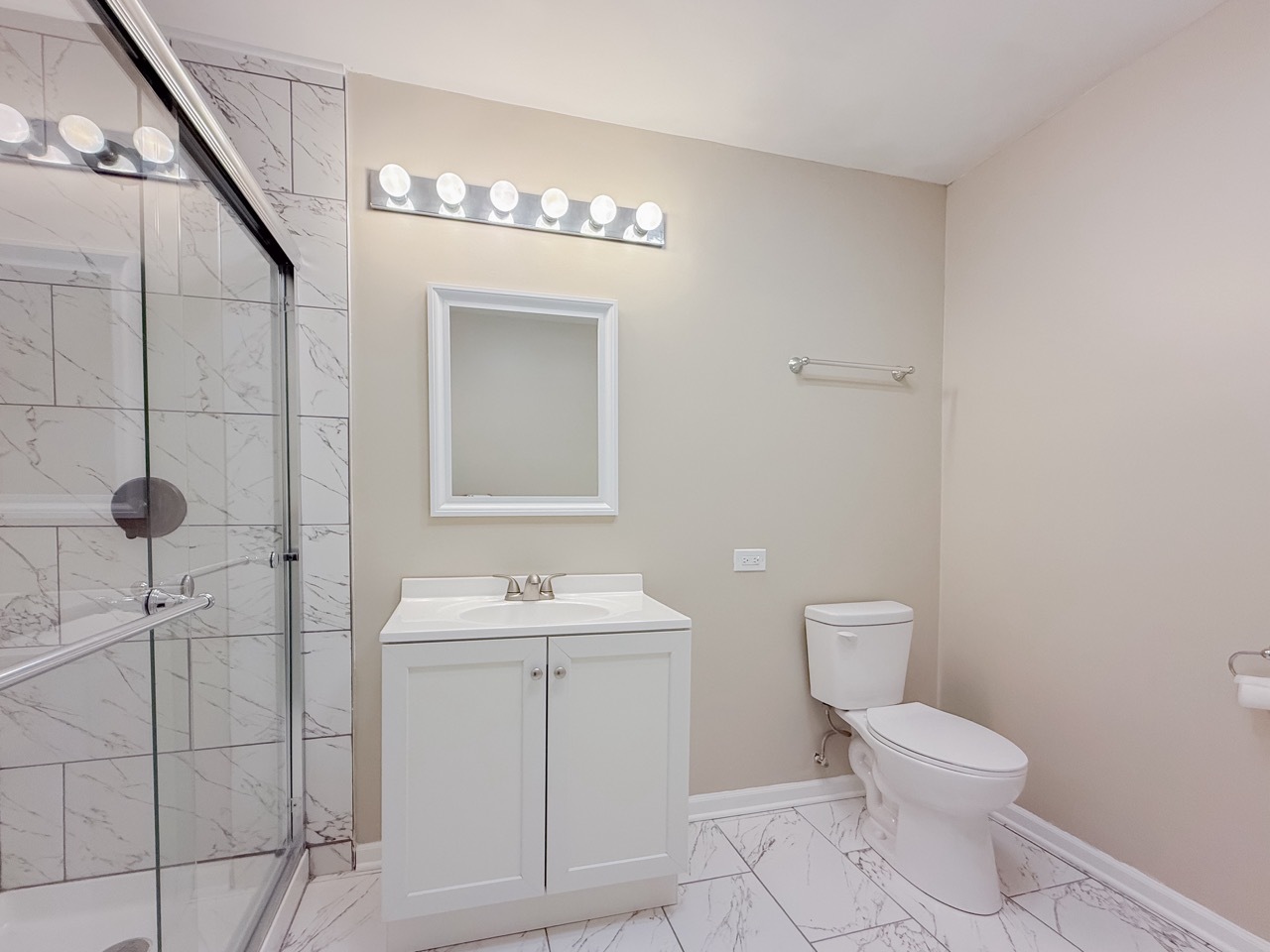 106 East State Road, Unit 2B Island Lake, IL 60042 - Photo 9 of 18 a bathroom with a toilet sink and mirror