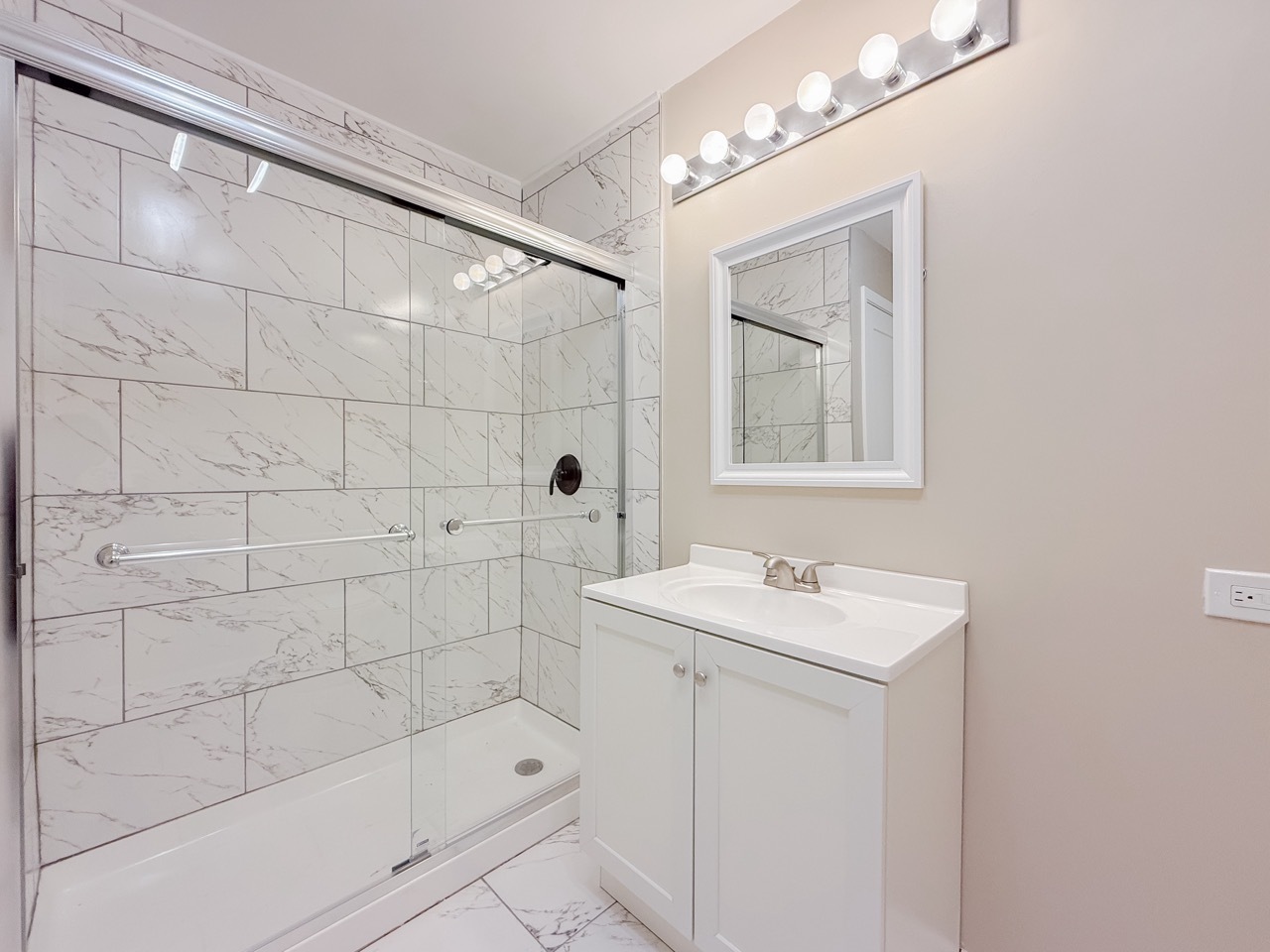 106 East State Road, Unit 2B Island Lake, IL 60042 - Photo 10 of 18 a bathroom with a sink a toilet a mirror and shower