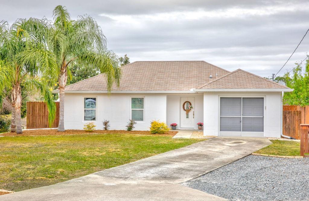 224 Deleon Road DeBary, FL 32713 - Photo 1 of 1 a front view of a house with a yard and garage