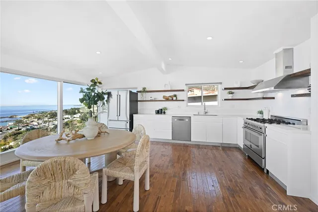 a kitchen with a table chairs stove and cabinets