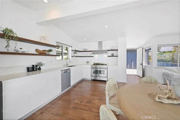 a kitchen with granite countertop a sink cabinets and window