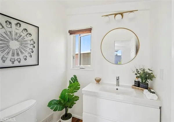 a bathroom with a sink mirror and vanity