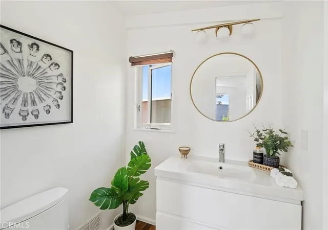 a bathroom with a sink mirror and vanity