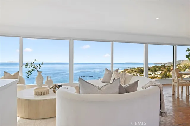 a living room with furniture and floor to ceiling windows