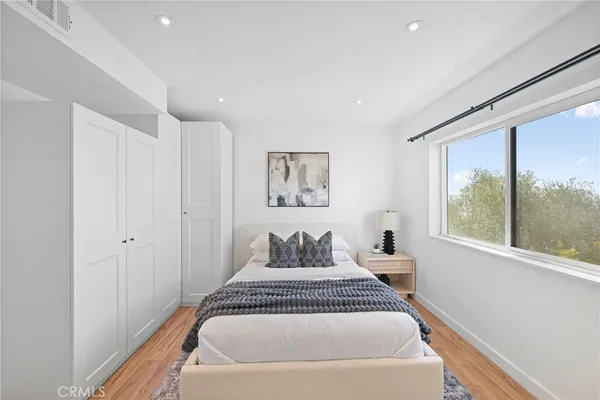 a spacious bedroom with a large bed and a large window