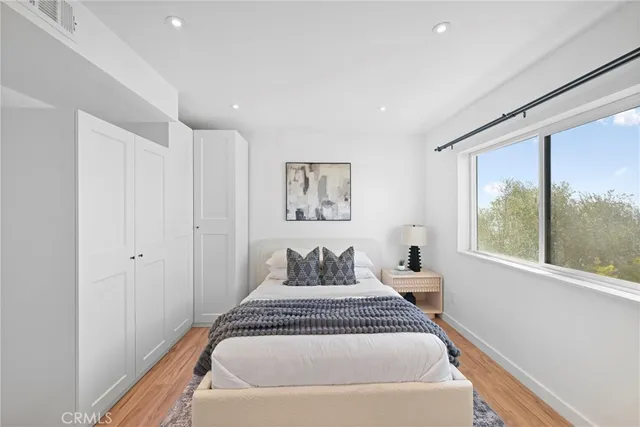 a spacious bedroom with a large bed and a large window