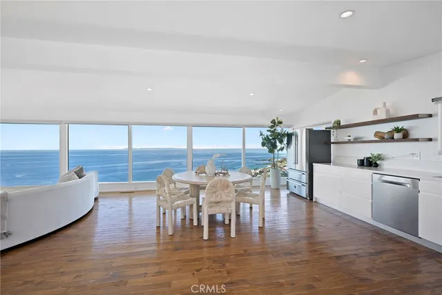 a dining room with furniture window and wooden floor