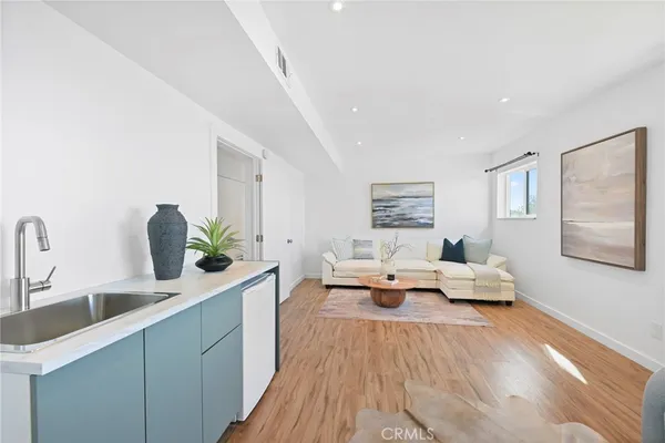 a living room with furniture window and wooden floor