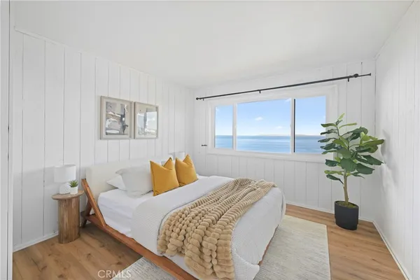 a bedroom with a bed and a potted plant