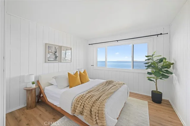 a bedroom with a bed and a potted plant