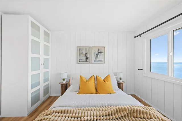 a bedroom with a bed and glass window