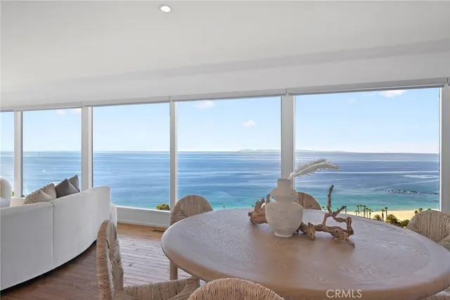 a dining room with furniture and a floor to ceiling window