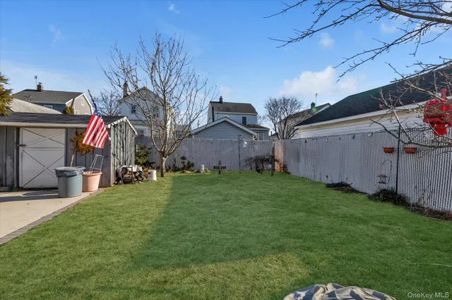 a view of a backyard with potted plants and large tree
