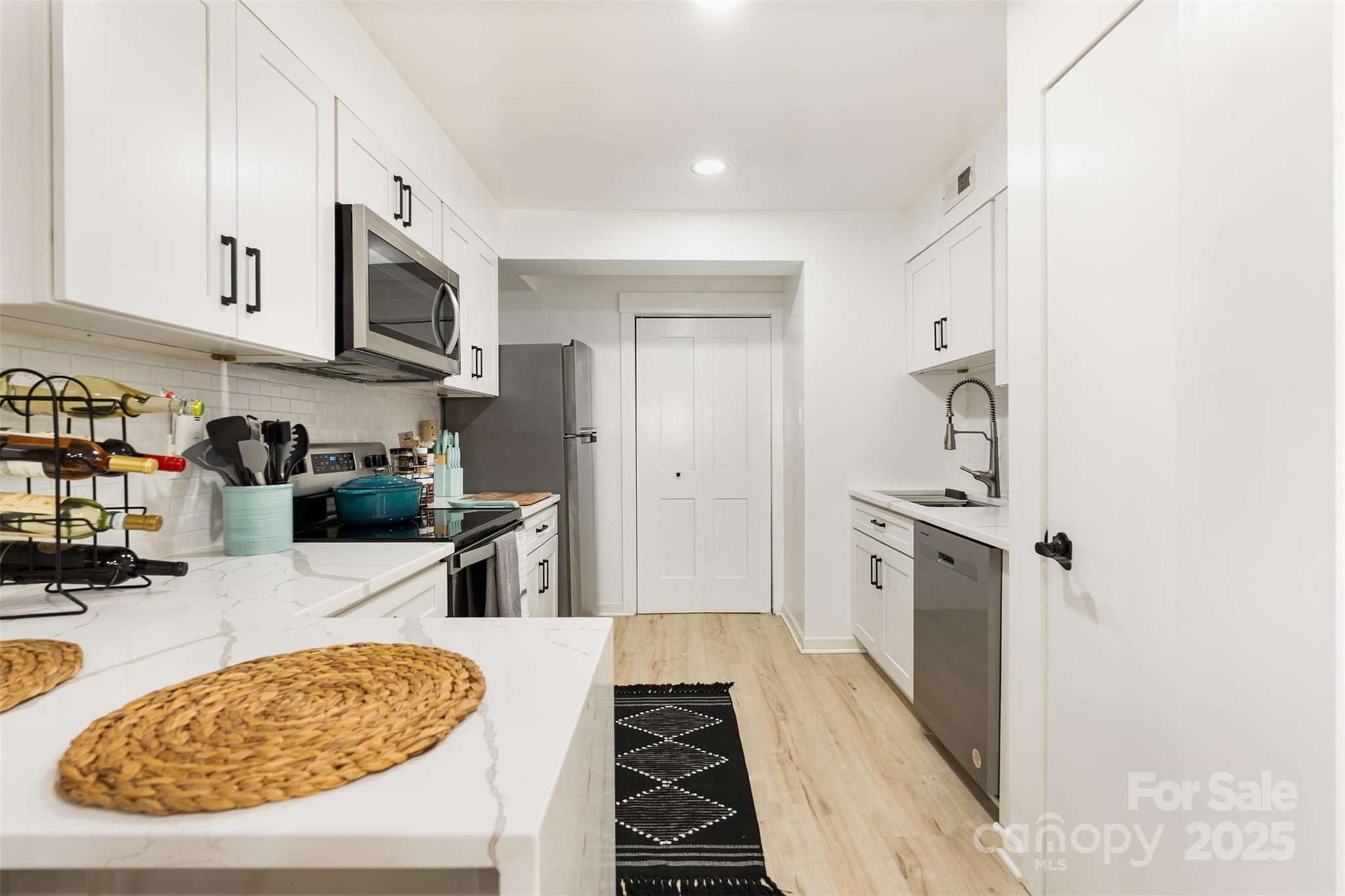 1635 Merry Oaks Road Charlotte, NC 28205 - Photo 6 of 15 a kitchen with stainless steel appliances granite countertop a stove and a refrigerator