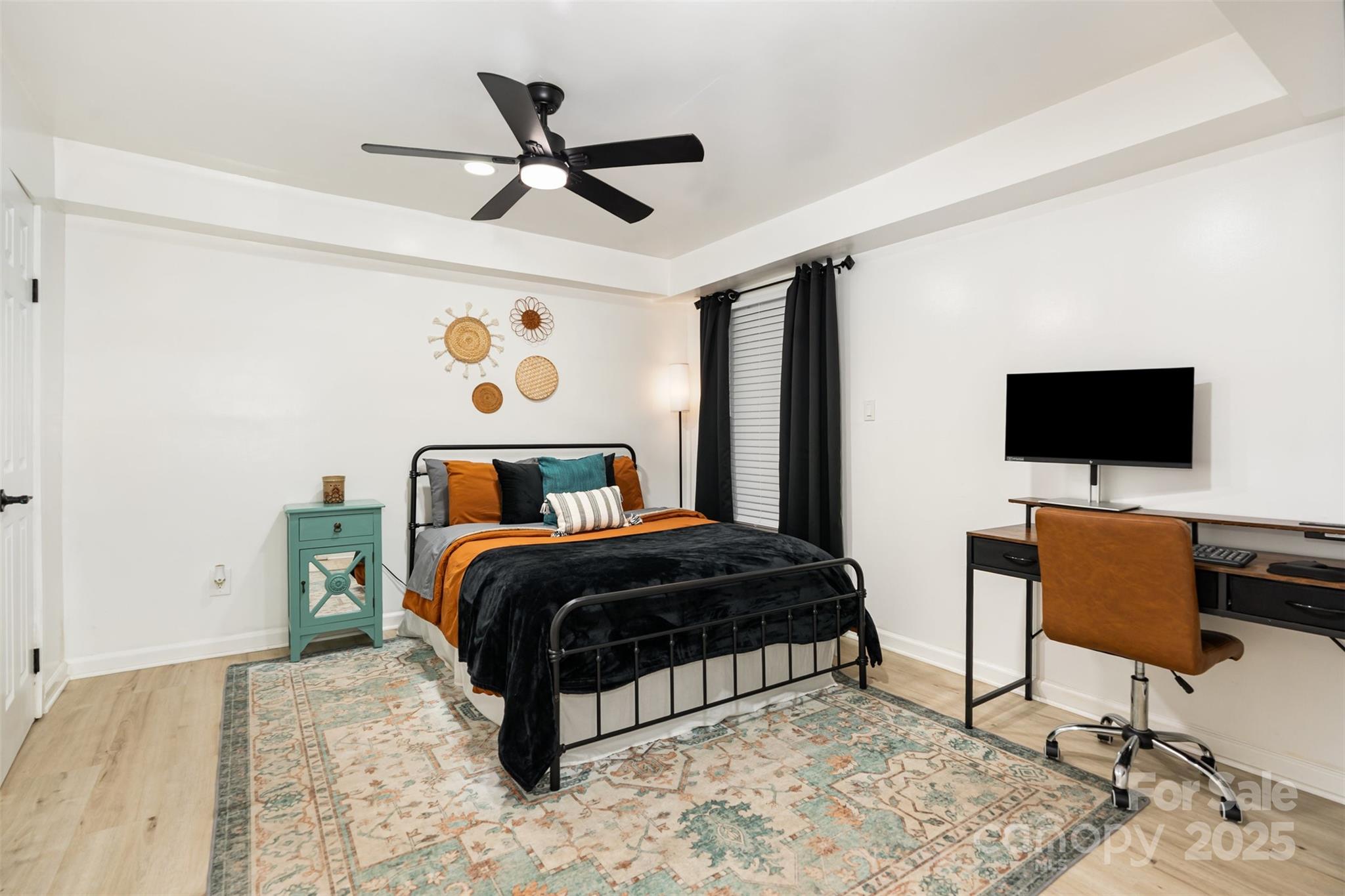 1635 Merry Oaks Road Charlotte, NC 28205 - Photo 10 of 15 a bedroom with a bed a chair and a flat screen tv