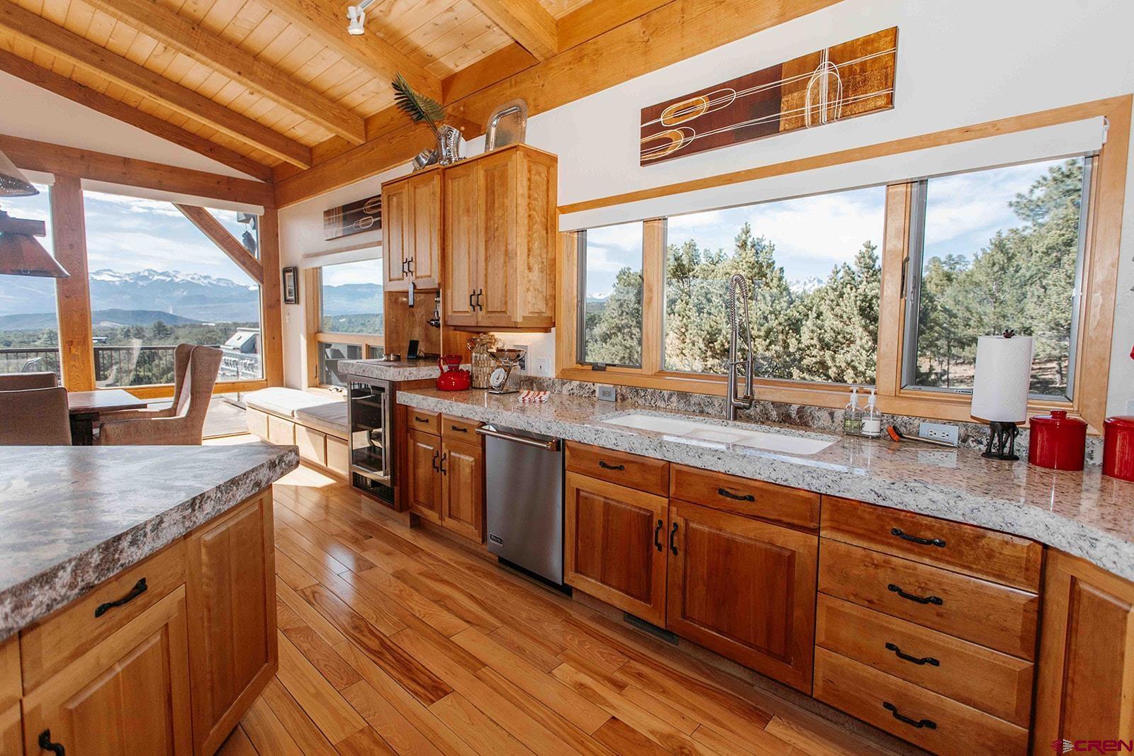 2118 Silverhorn Trail Ridgway, CO 81432 - Photo 12 of 35 a kitchen with stainless steel appliances granite countertop a stove a sink and a granite counter tops with a large window
