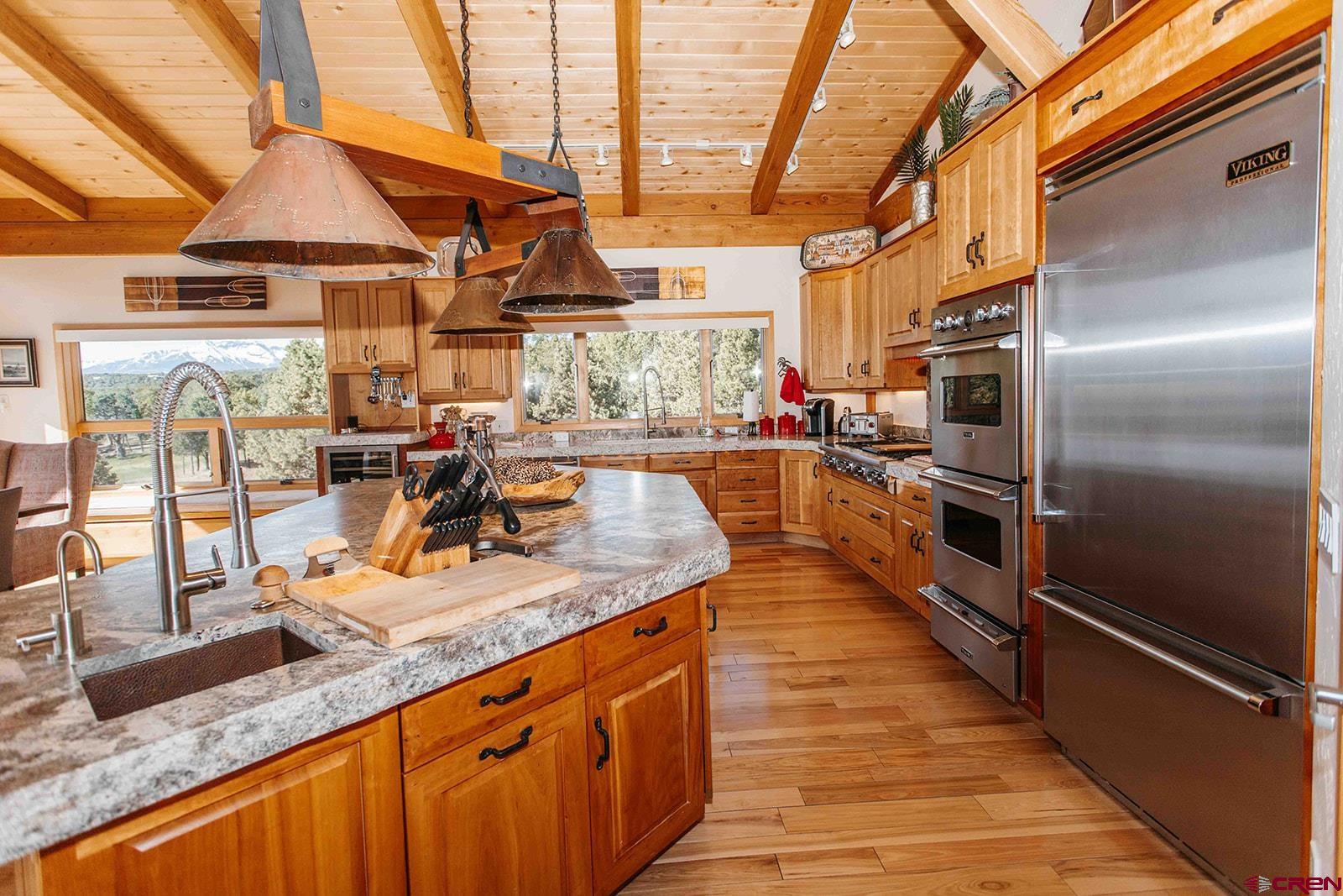 2118 Silverhorn Trail Ridgway, CO 81432 - Photo 14 of 35 a kitchen with stainless steel appliances granite countertop lots of counter top space and wooden floor