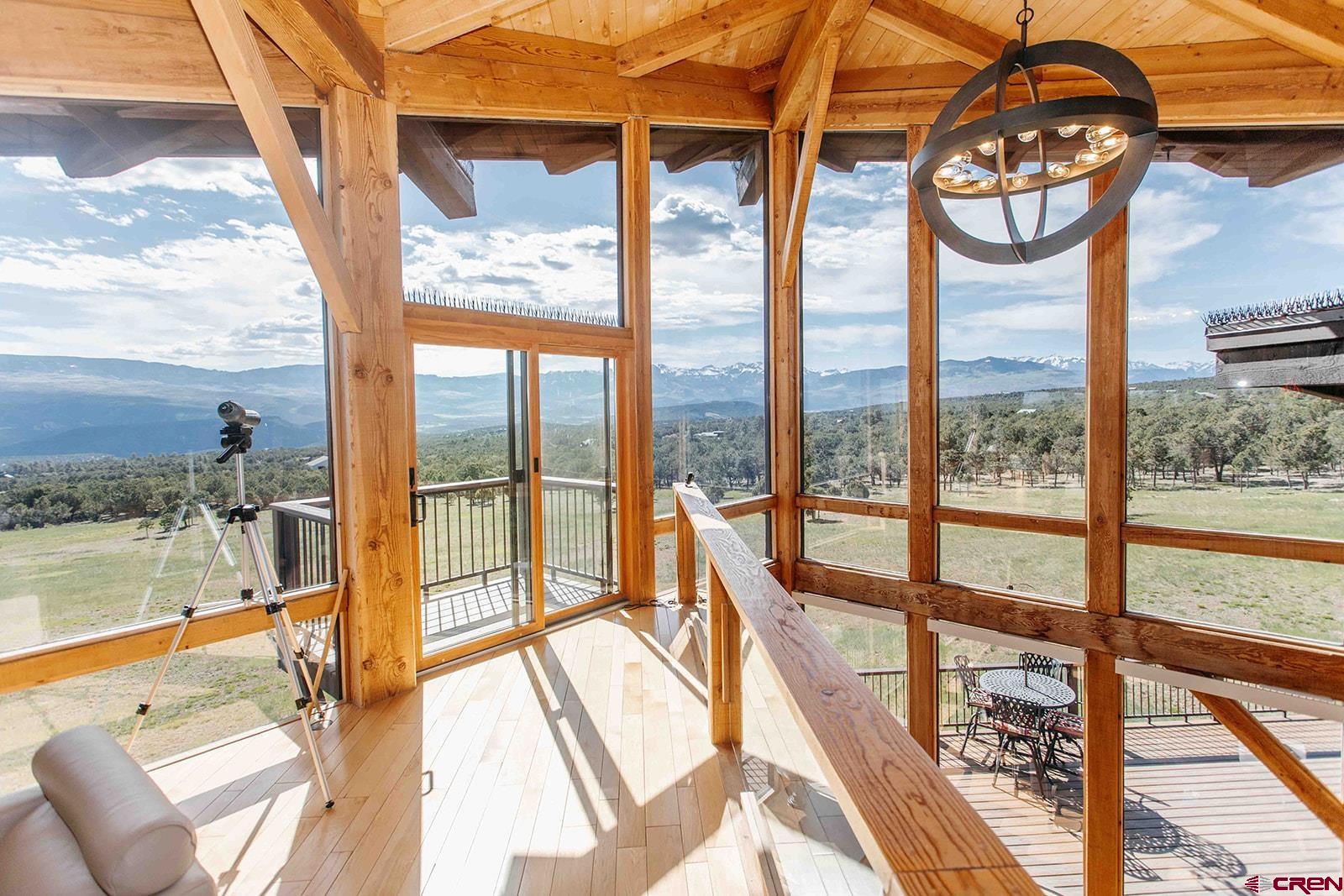 2118 Silverhorn Trail Ridgway, CO 81432 - Photo 16 of 35 a view of a living room and kitchen with a floor to ceiling window