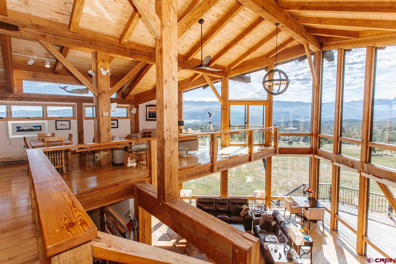 2118 Silverhorn Trail Ridgway, CO 81432 - Photo 18 of 35 a view of a living room with furniture and floor to ceiling windows