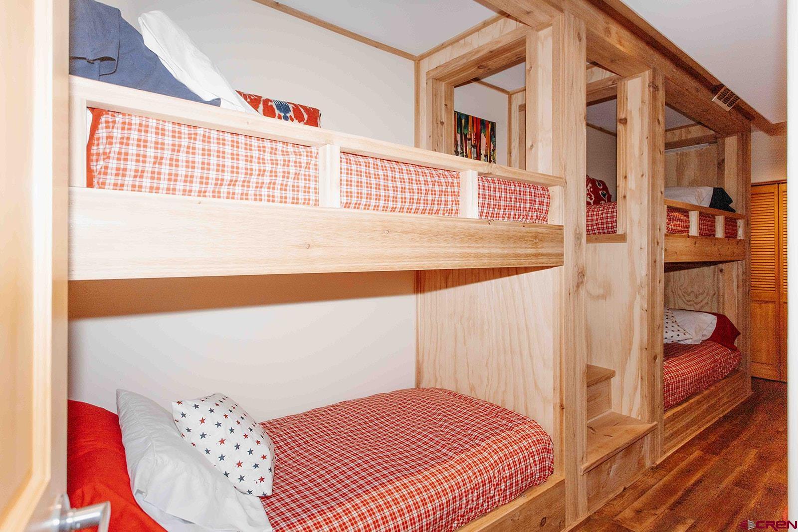 2118 Silverhorn Trail Ridgway, CO 81432 - Photo 23 of 35 a bedroom with a bed and a book shelf